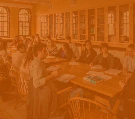 A group of business students learn together at a large table.